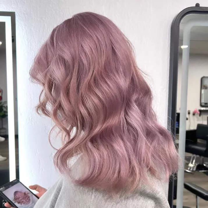 Wavy pastel pink hair viewed from back