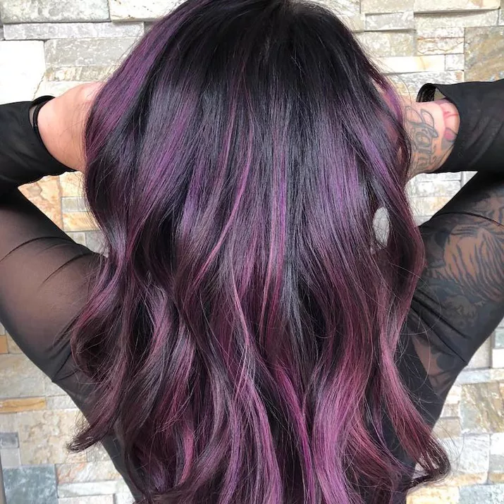 Dark hair with purple highlights in loose curls