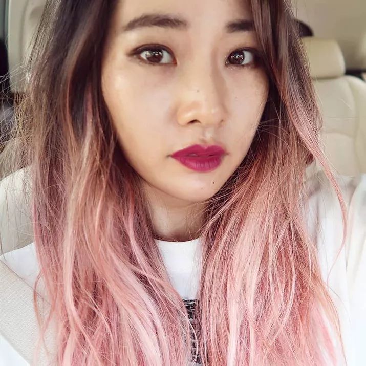Woman with long light pink ombre hair
