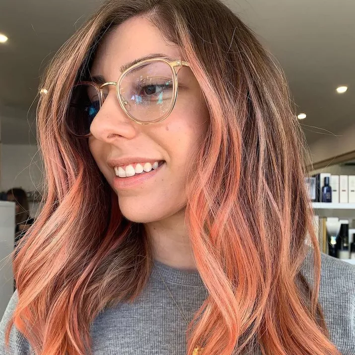 Woman with brunette to peach ombre hair