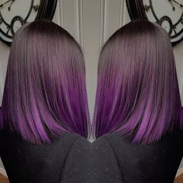Mirror image of a sleek lob with purple highlights