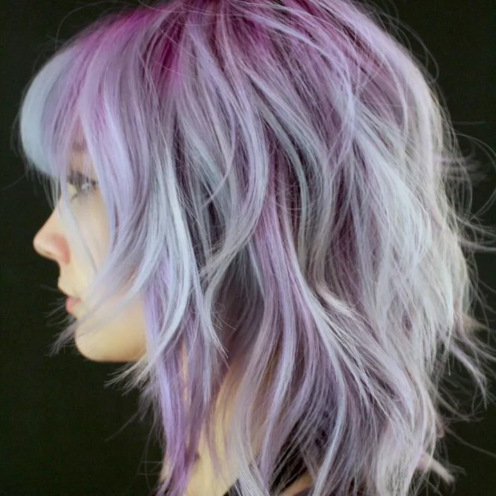 Wavy shag haircut with silver and purple highlights