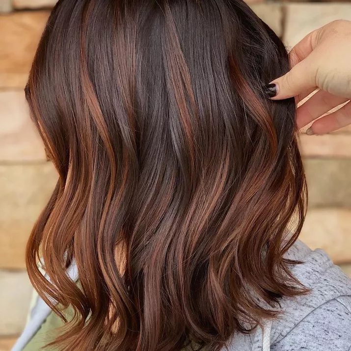 Tousled bob haircut with bronze highlights