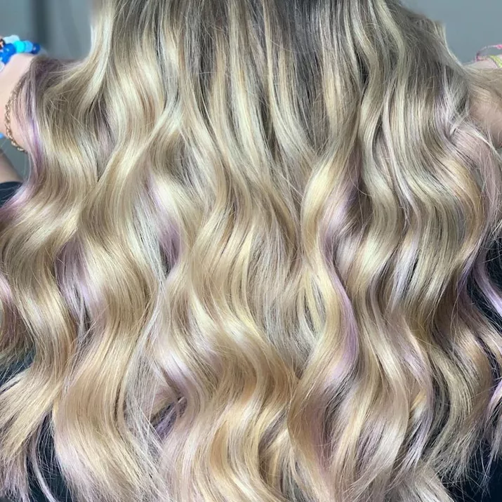 Bright blonde hair with subtle purple highlights