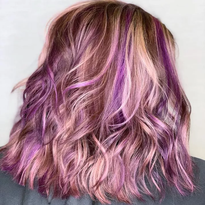 Blonde shoulder-length hair with bright purple highlights