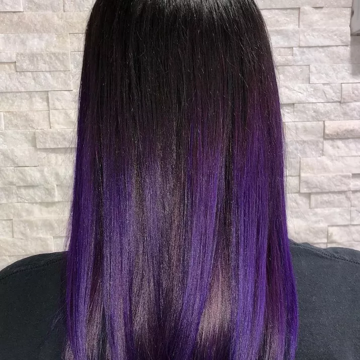 Dark, sleek hair with purple highlights