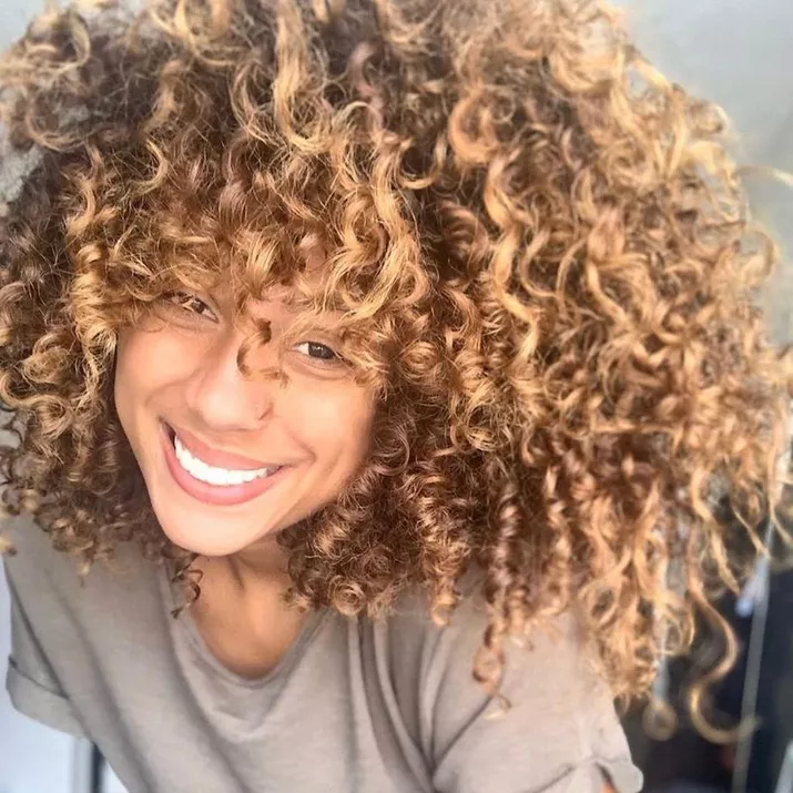 Woman with curly golden bronze hair