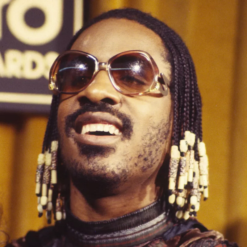 Stevie Wonder wears small braids with beads at the 1977 Billboard Music Awards