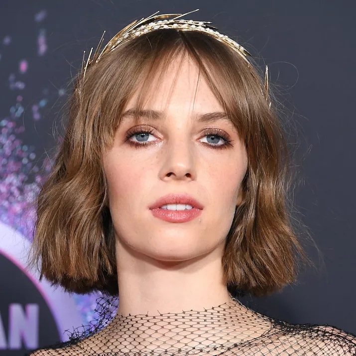 Maya Hawke wears a minimal makeup look with prominent bottom lashes