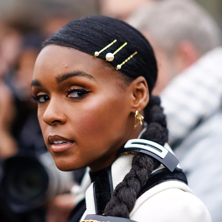 Janelle Monae with an accessorized low braid