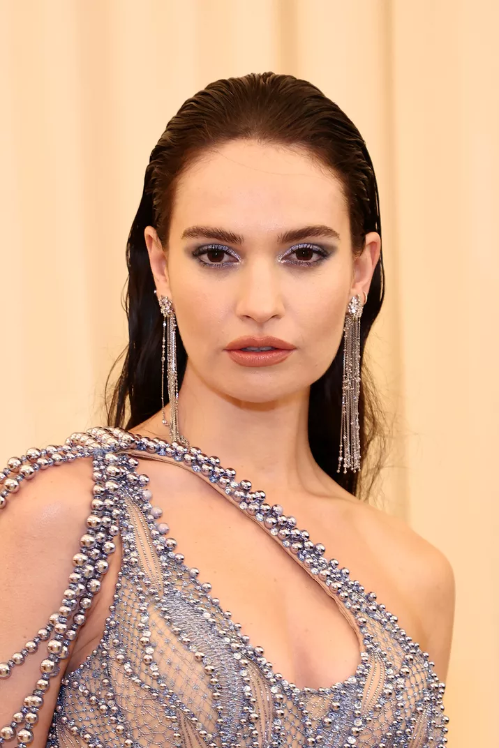 Lily James wearing a gelled back hairstyle