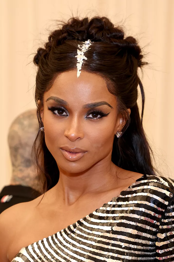 Ciara in a half-up half-down hairstyle with an accessorized center part