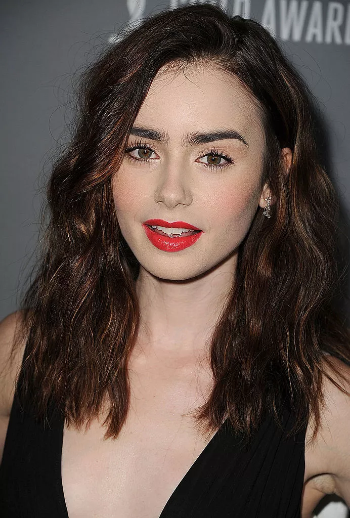 Lilly Collins medium-length crimped hair with red lip