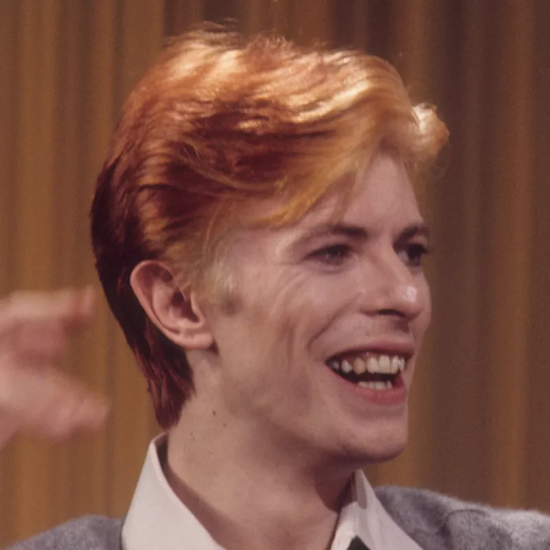 David Bowie wears a short feathered haircut