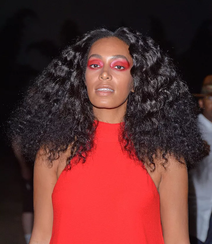 Solange with long, natural hair and red eye makeup