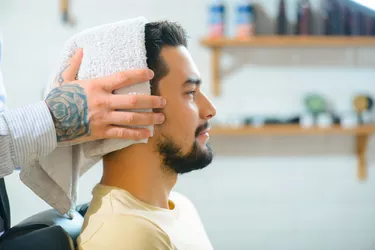 man getting his hair towel dried