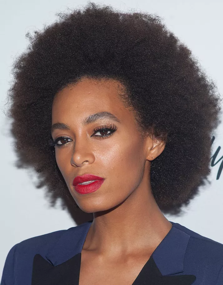 Solange afro with red lipstick