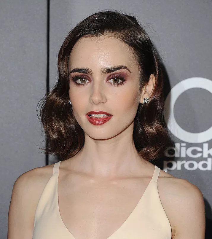 Lily Collins side-parted chic bob with retro waves