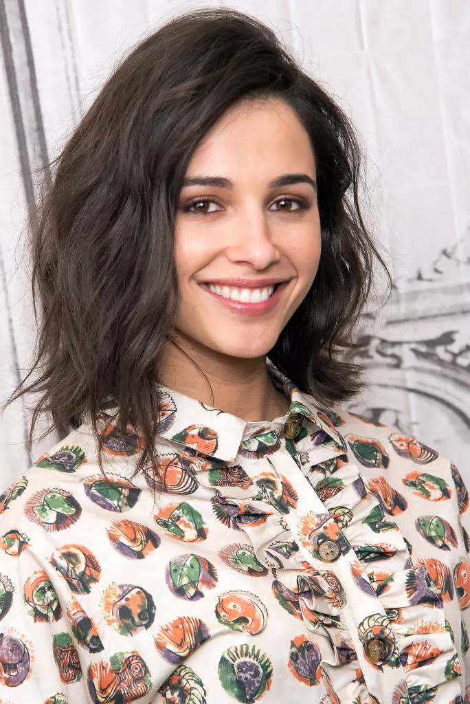 Naomi Scott deep side-parted tousled lob