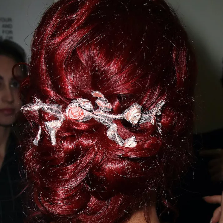 A back view of Sharna Burgess' burgundy hair