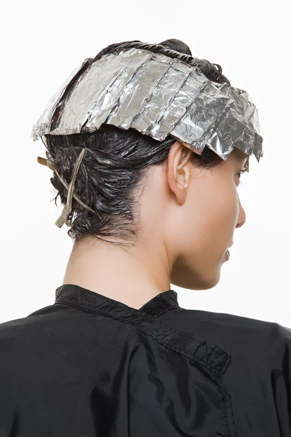 Woman in the process of getting foil highlights