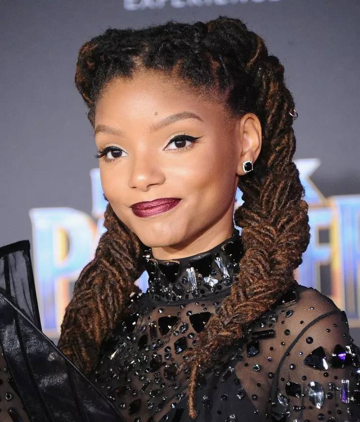 Halle Bailey with her locs braided into pigtails.
