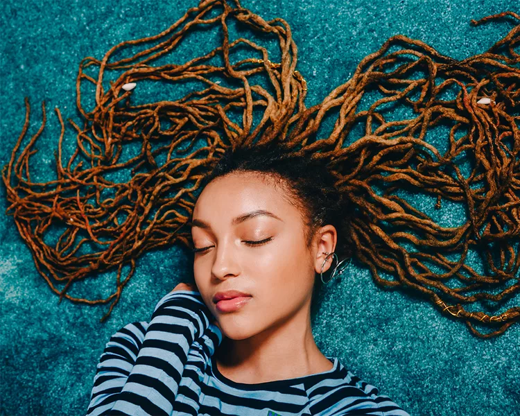high angle portrait of mixed femme with dreadlocs