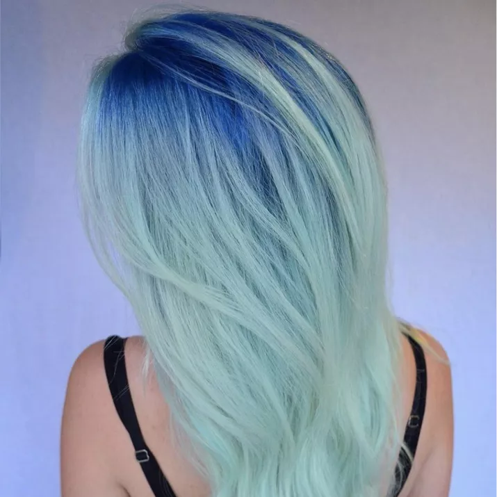 Icy blue ombre hairstyle with dark blue roots