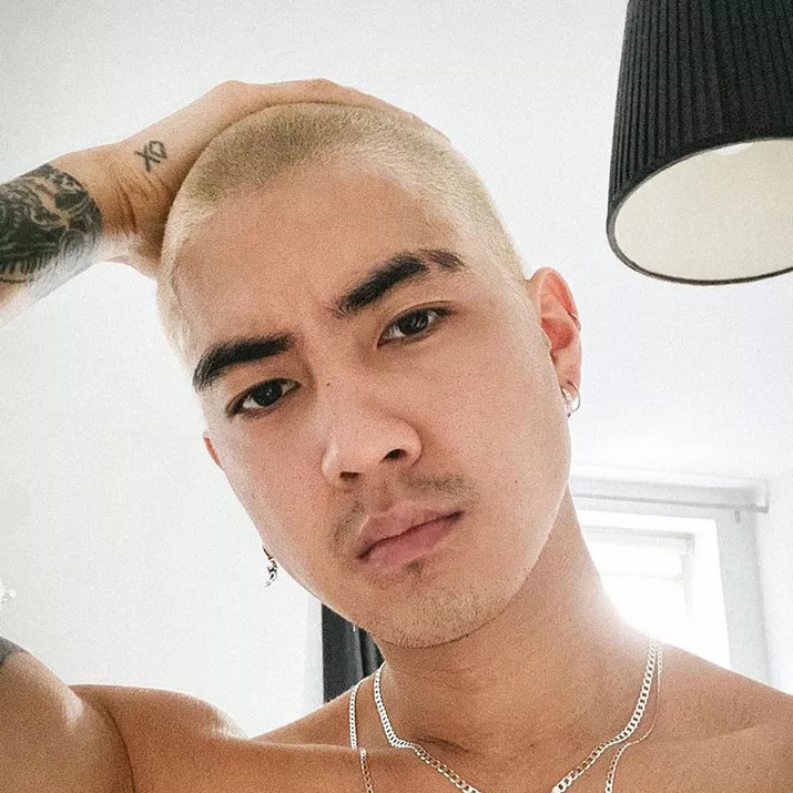Young man touching his bleached hair