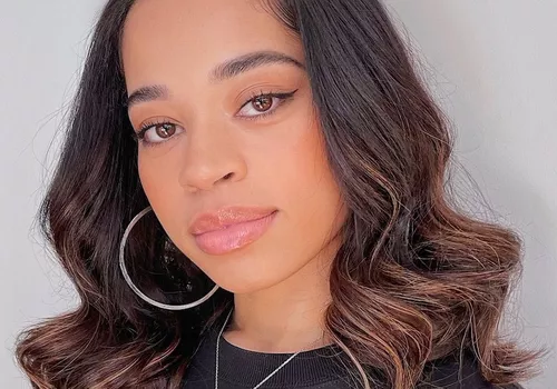 Ella Mai with a sew-in hairstyle.