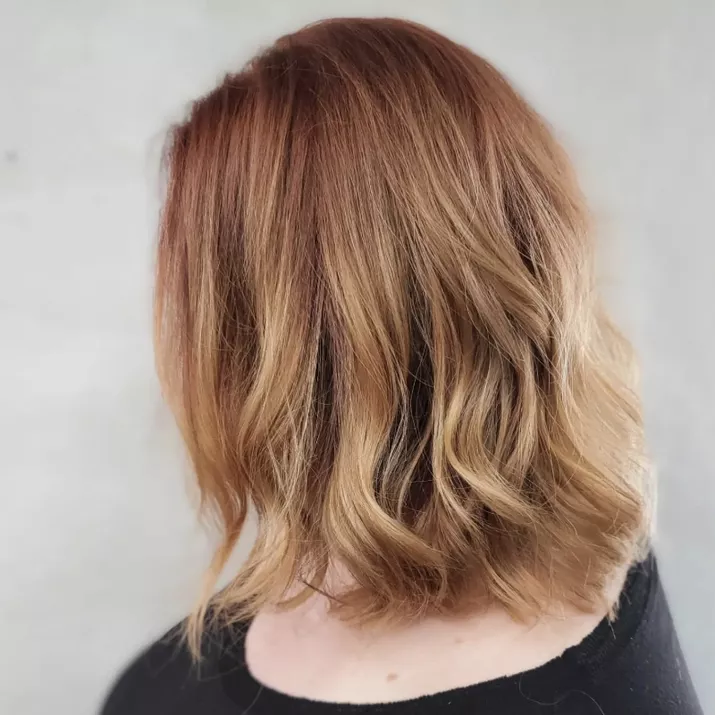 Strawberry blonde highlights on long bob hairstyle