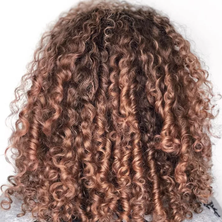 Curly brunette hair with strawberry blonde highlights
