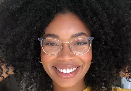 woman smiling posing with curly wash and go hair