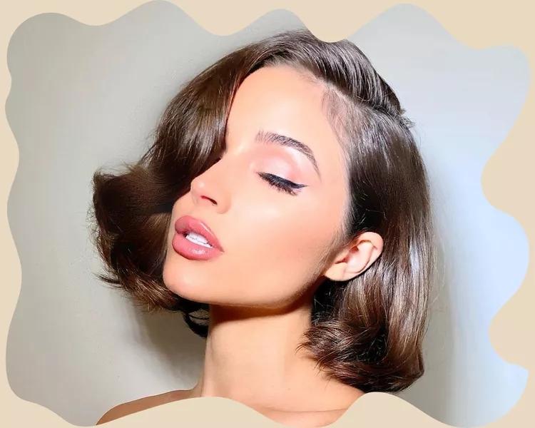 Olivia Culpo with side swept bangs.