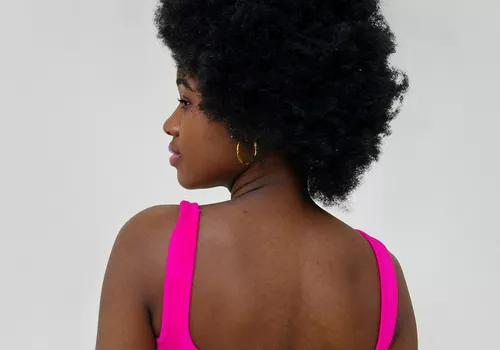 woman in pink tank top with natural hair