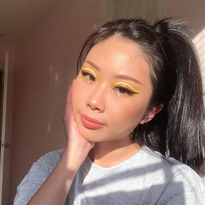 Makeup artist Christine Kim wears a yellow eyeshadow look