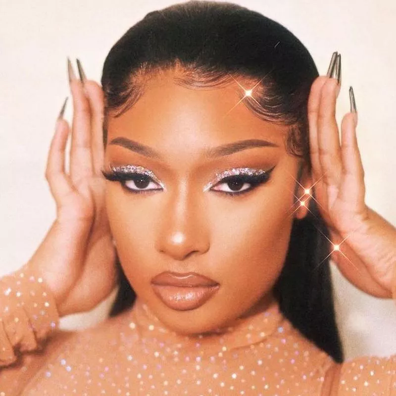 Megan Thee Stallion wears silver glitter cut crease eyeshadow with winged liner