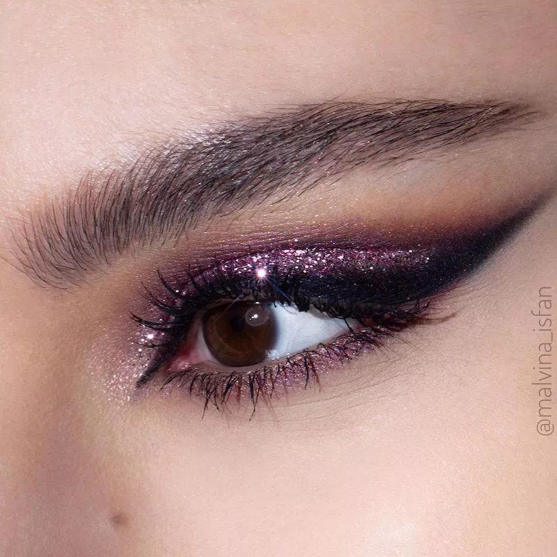 Purple glitter eye makeup with smoky cut crease