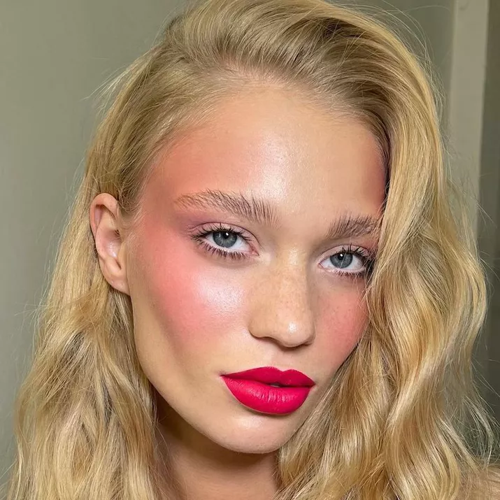 Model with blended pink blush and hot pink lipstick
