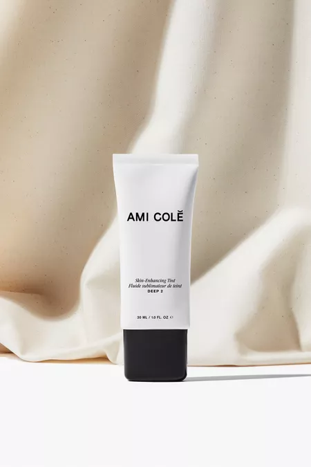 bottle of ami cole against white backdrop