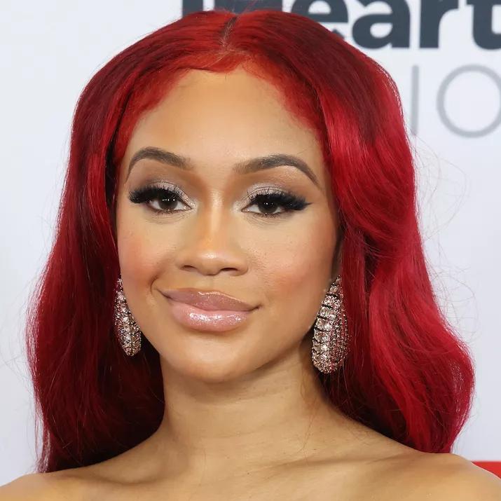 Saweetie wears a glossy makeup look with false lashes