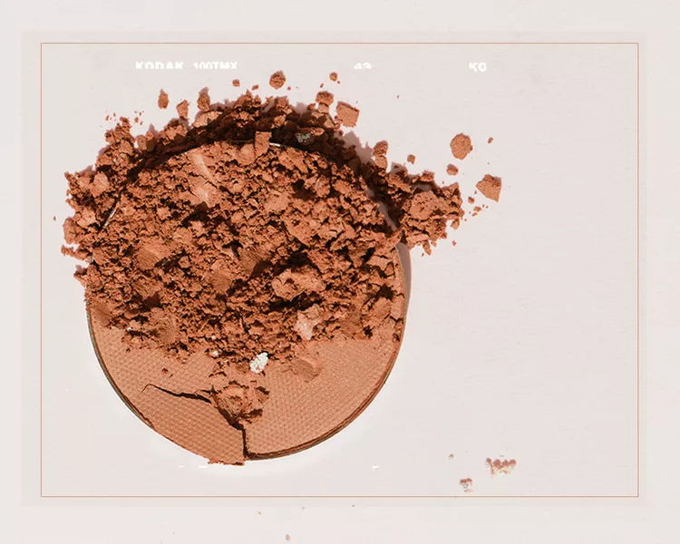 A Warm Toned Contour Shade in a Powder Palette with Some Spilled Off to the Side