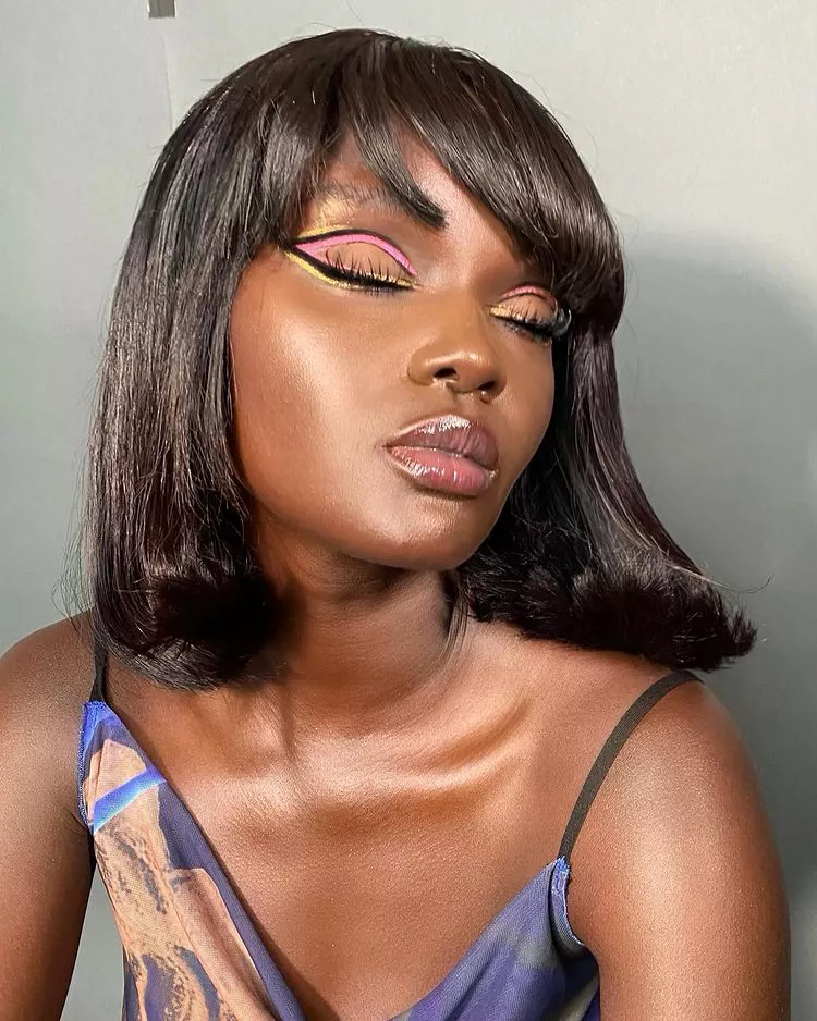 Woman with black, pink, and yellow double winged liner