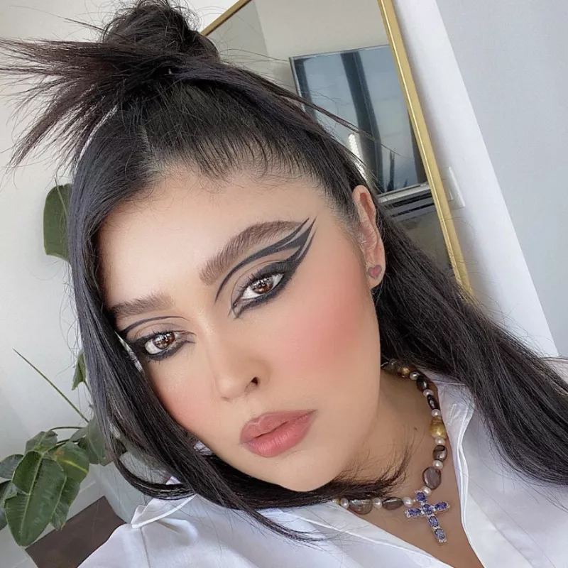 Priscilla Ono wears triple-stacked graphic winged eyeliner