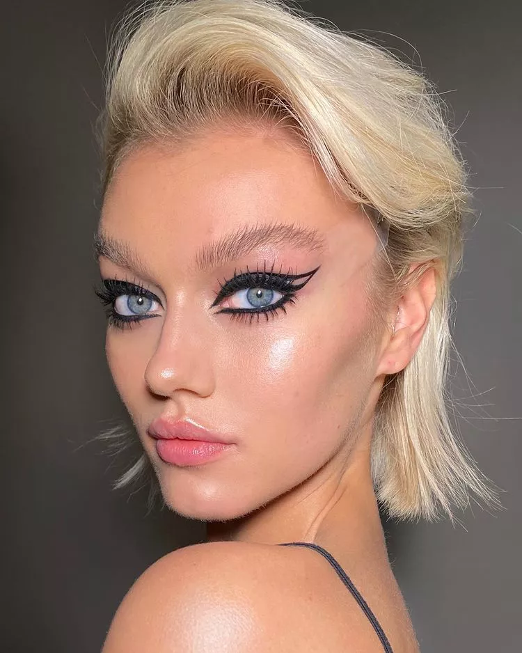 Model wearing double winged graphic eyeliner
