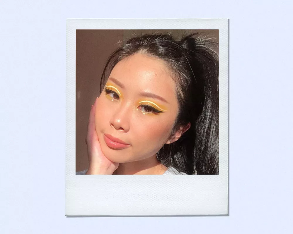 woman wearing yellow eyeshadow liner