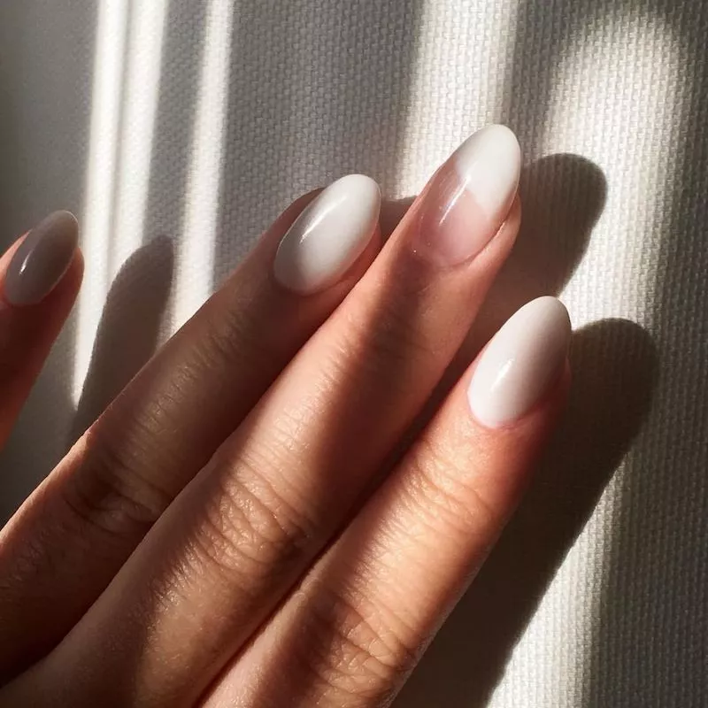 Dip powder manicured nails in white