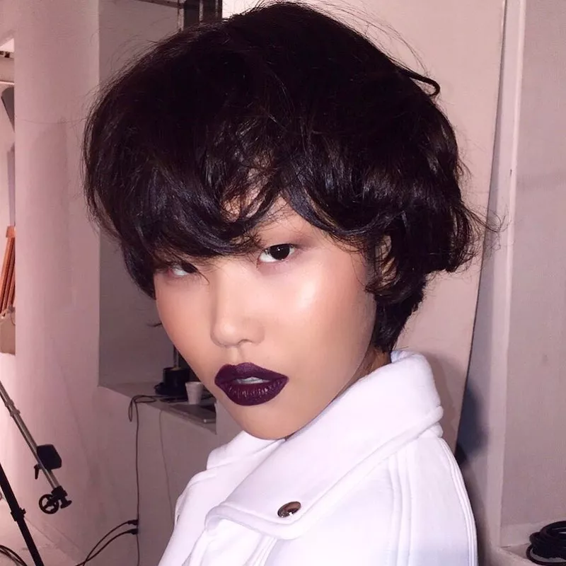 Model with short, tousled hair and burgundy lipstick