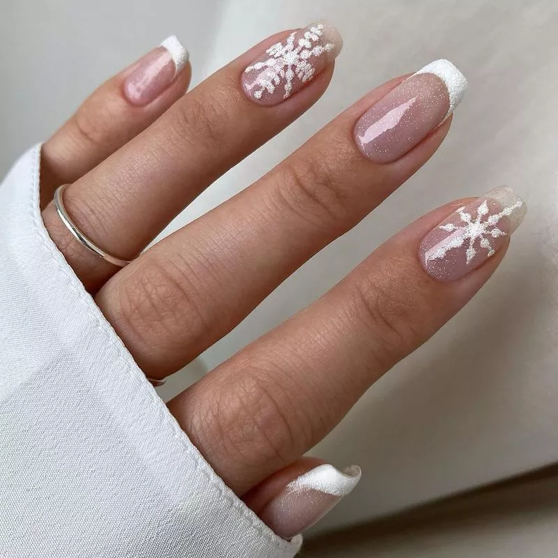 French manicure with sheer shimmer overlay and white snowflake accent nails