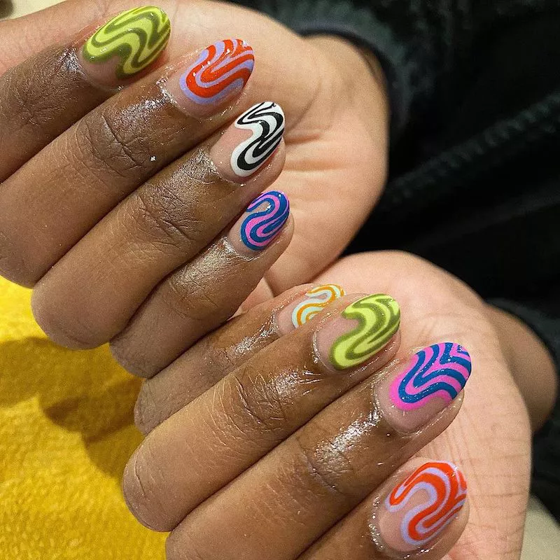 Negative space nails with colorful abstract swirls